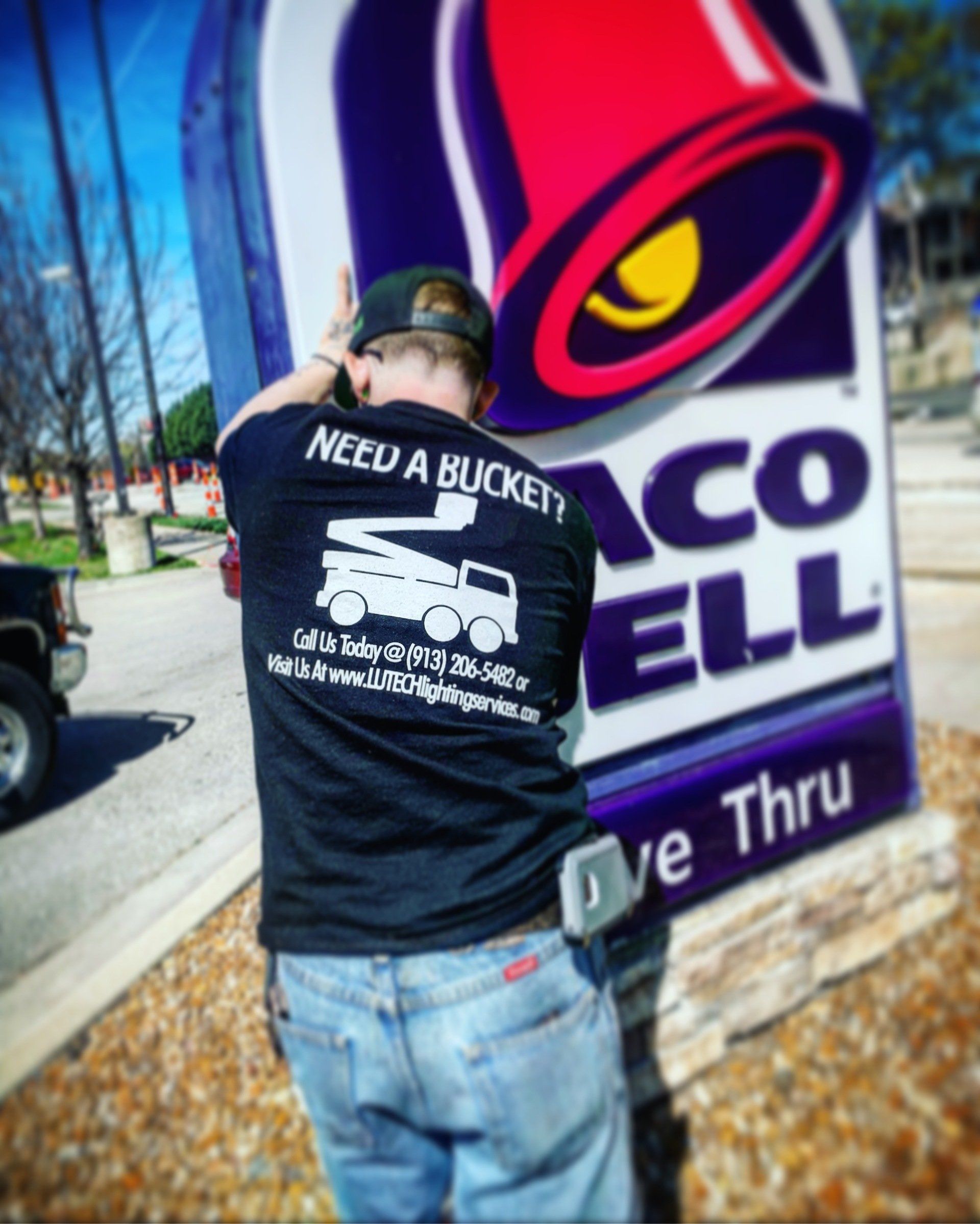 A man standing in front of a taco bell sign