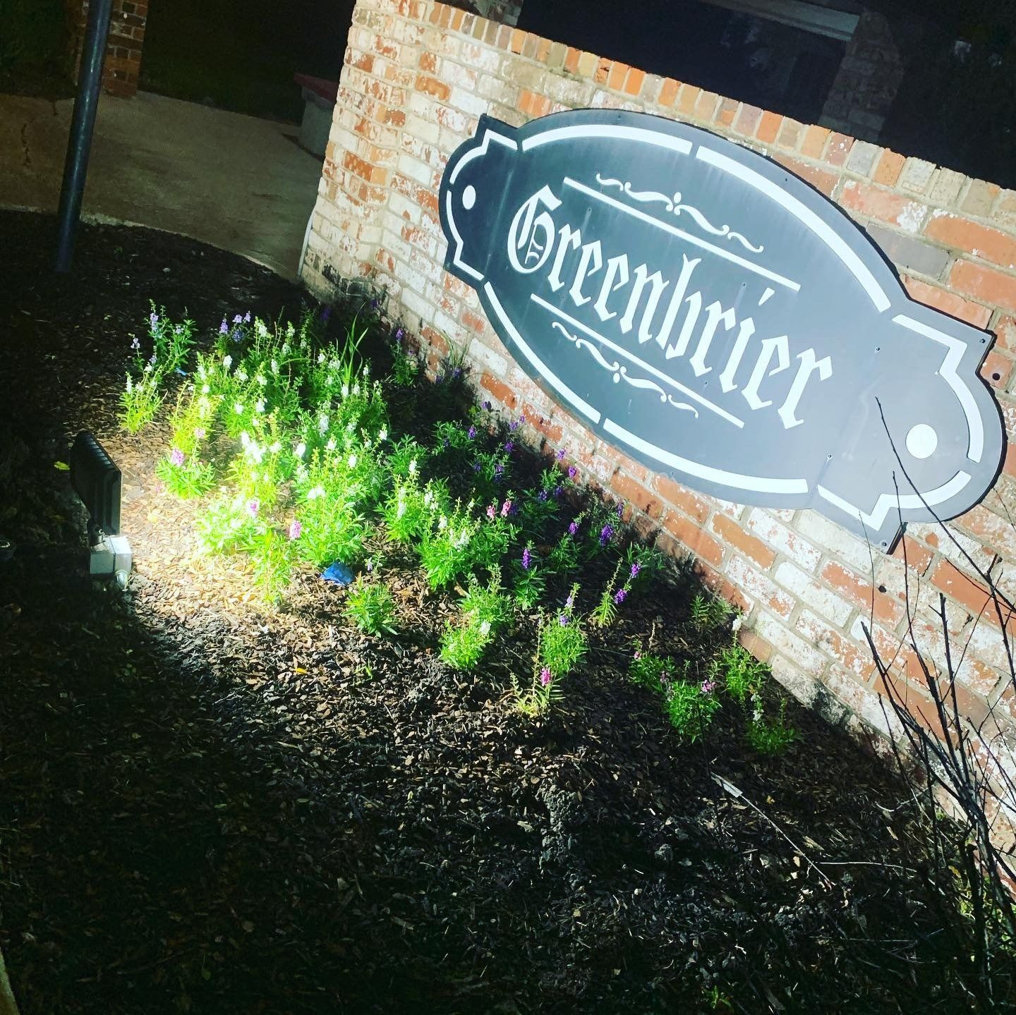A sign on a brick wall that says greenbriar