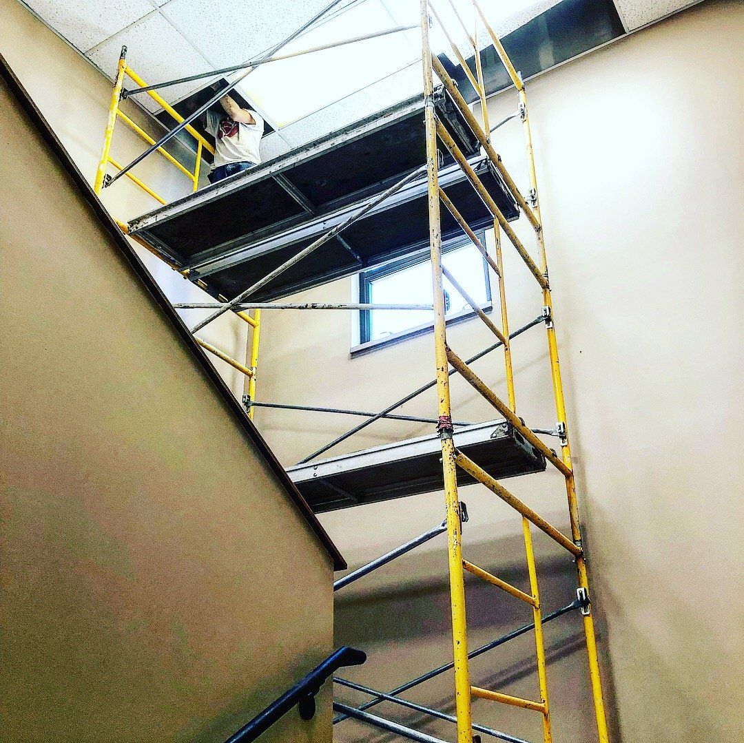 A yellow scaffolding is attached to the side of a staircase