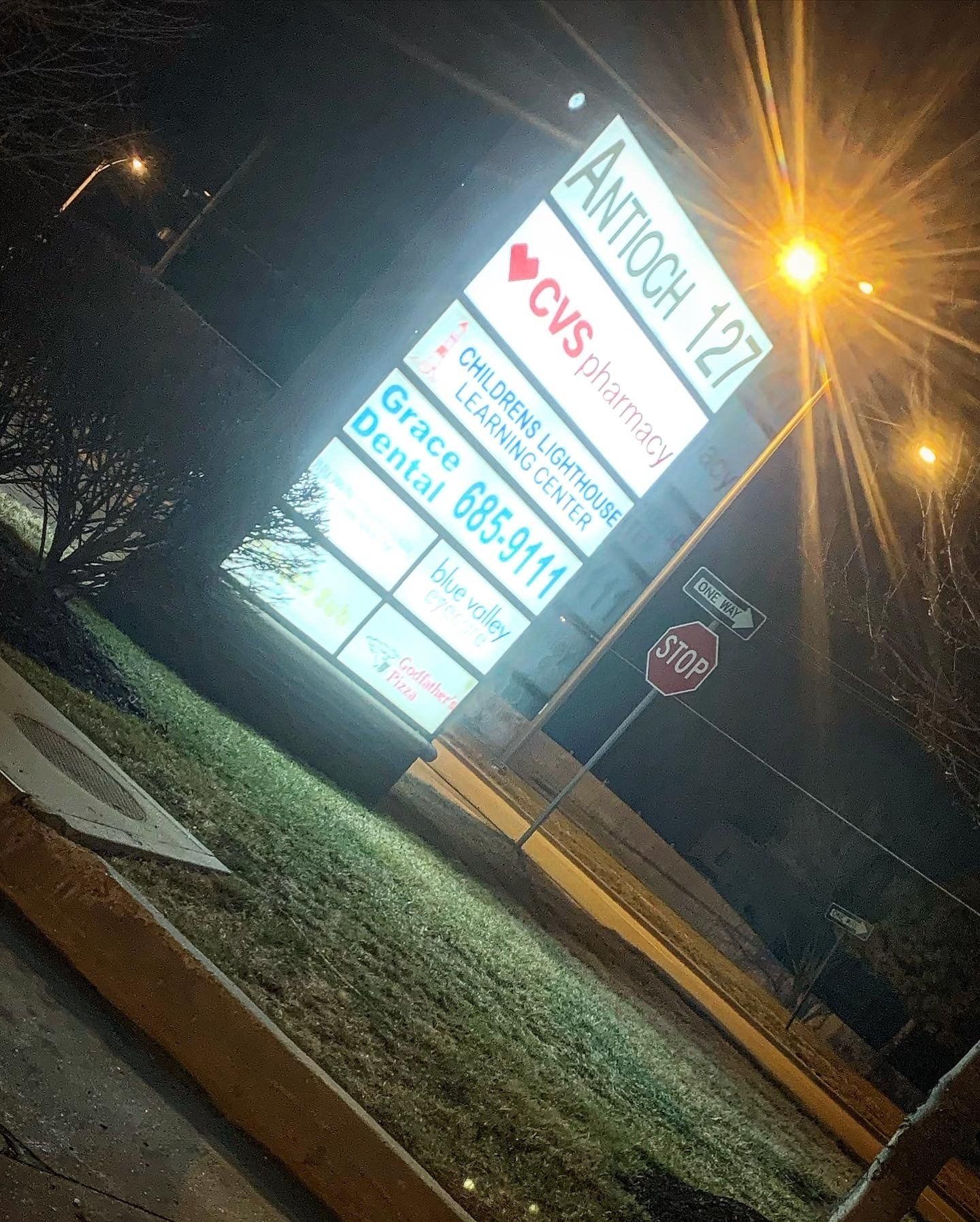 A sign for cvs is lit up at night