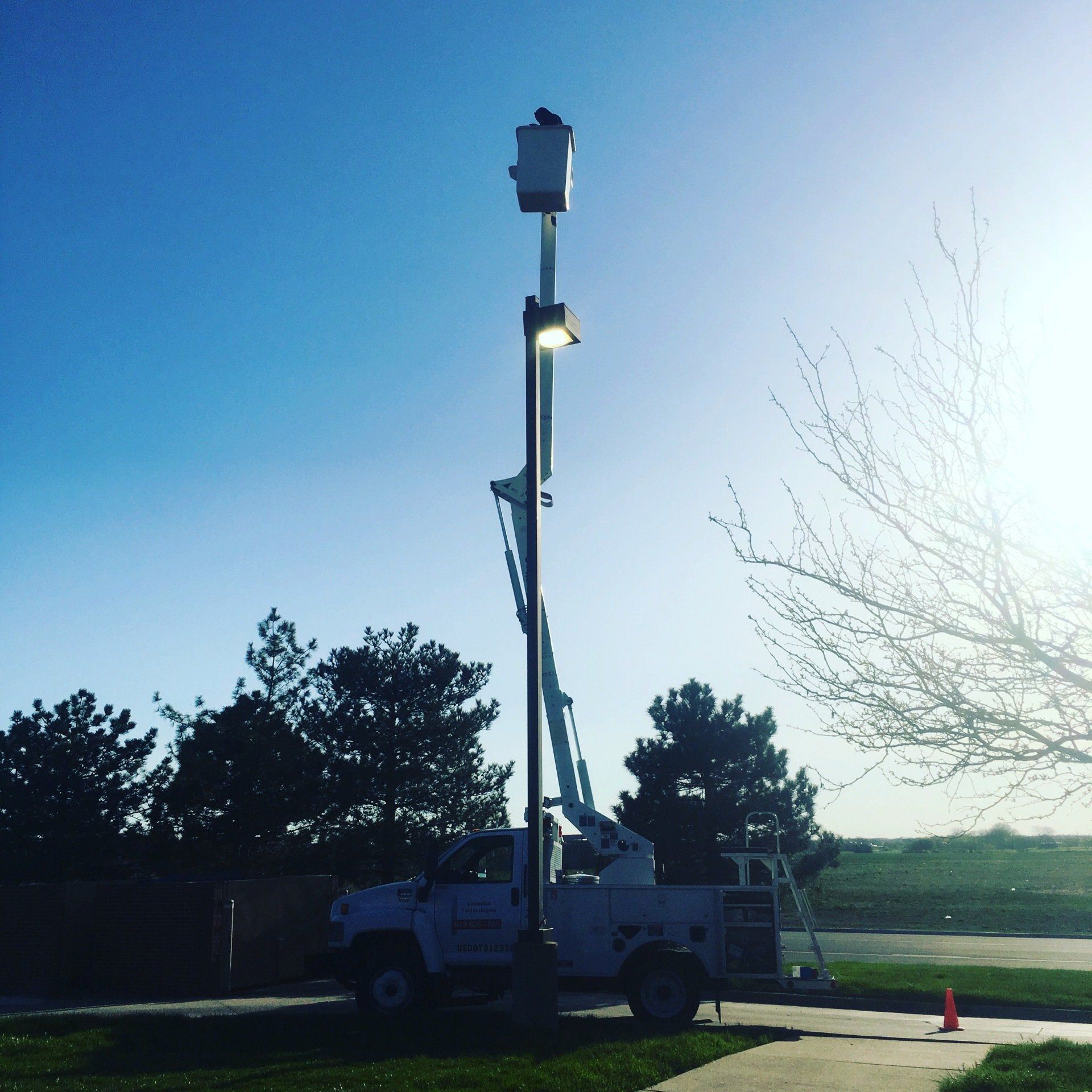 A white truck with a bucket on top of it