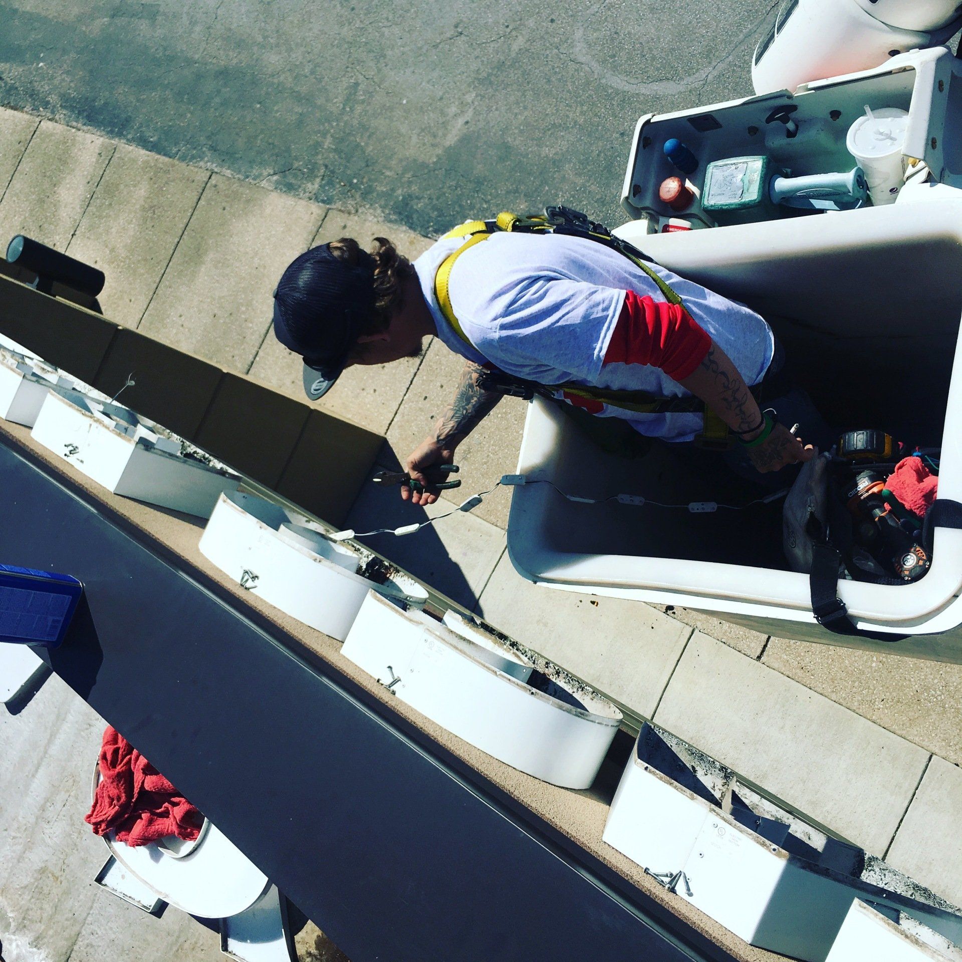 A man in a safety harness is working on a building