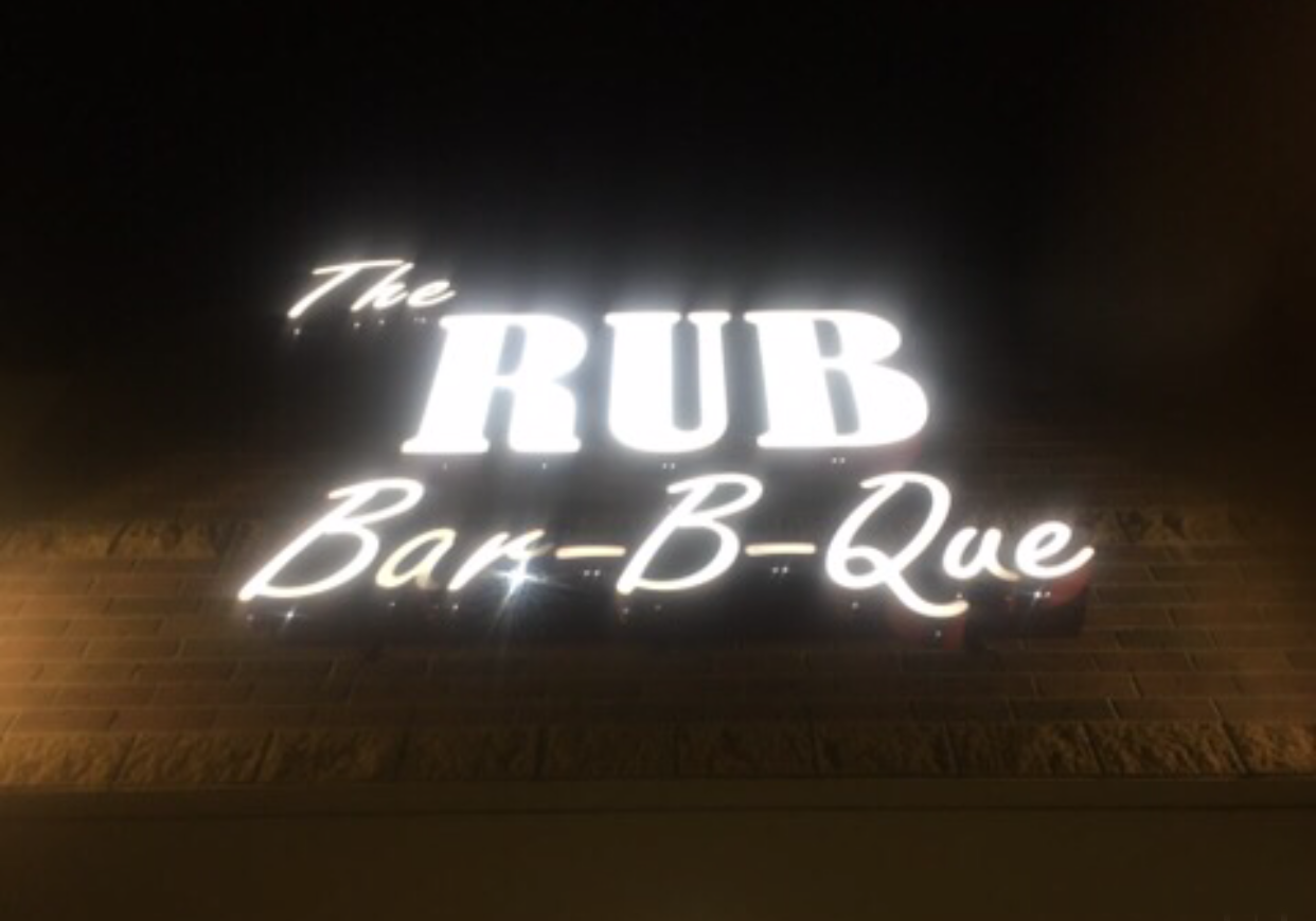 A neon sign that says the rub bar-b-que
