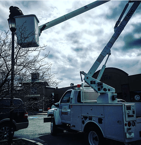 A utility truck with a bucket on top of it