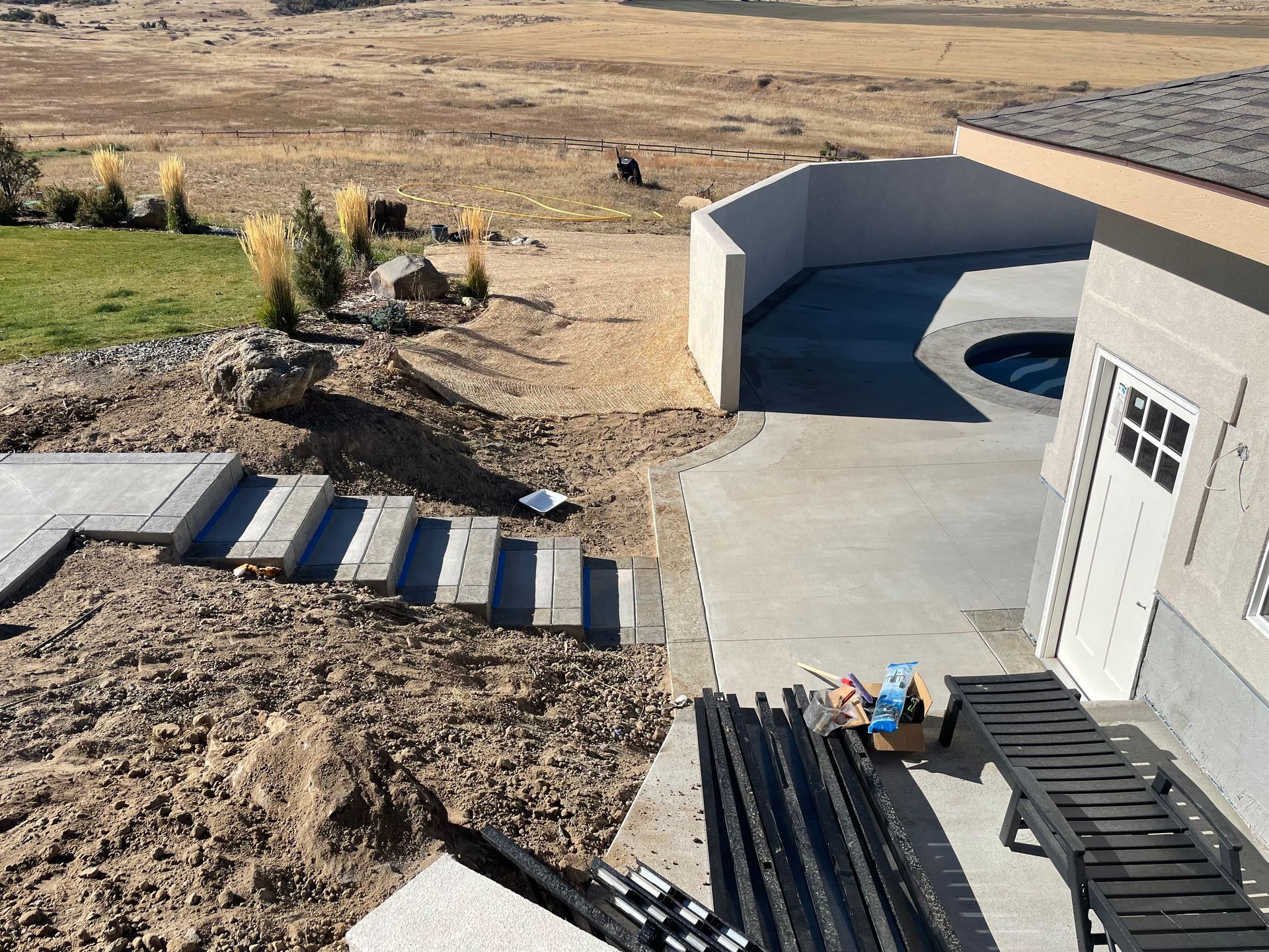 An aerial view of a house under construction with a pool in the backyard.