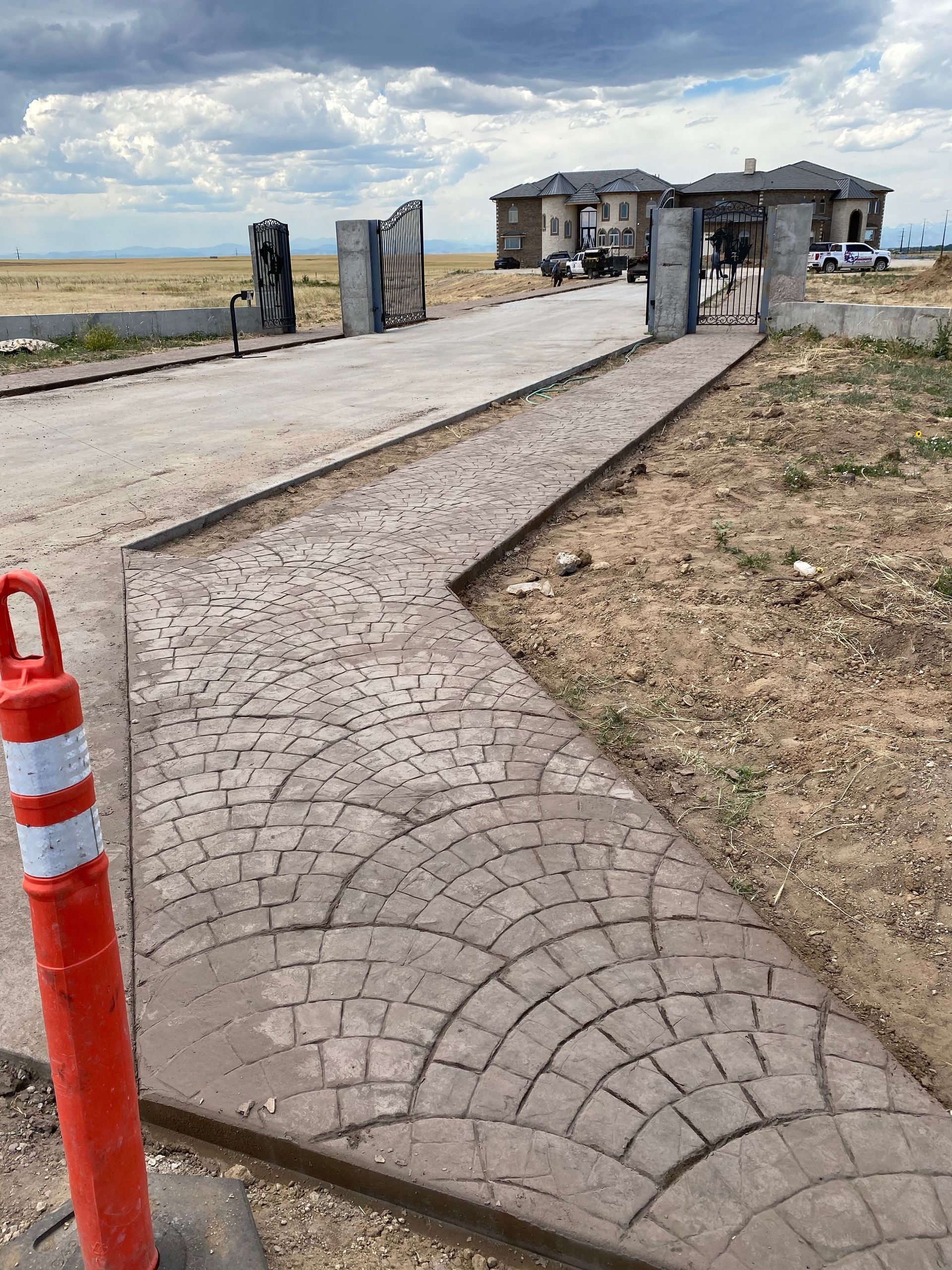 A concrete walkway is being built in front of a house.