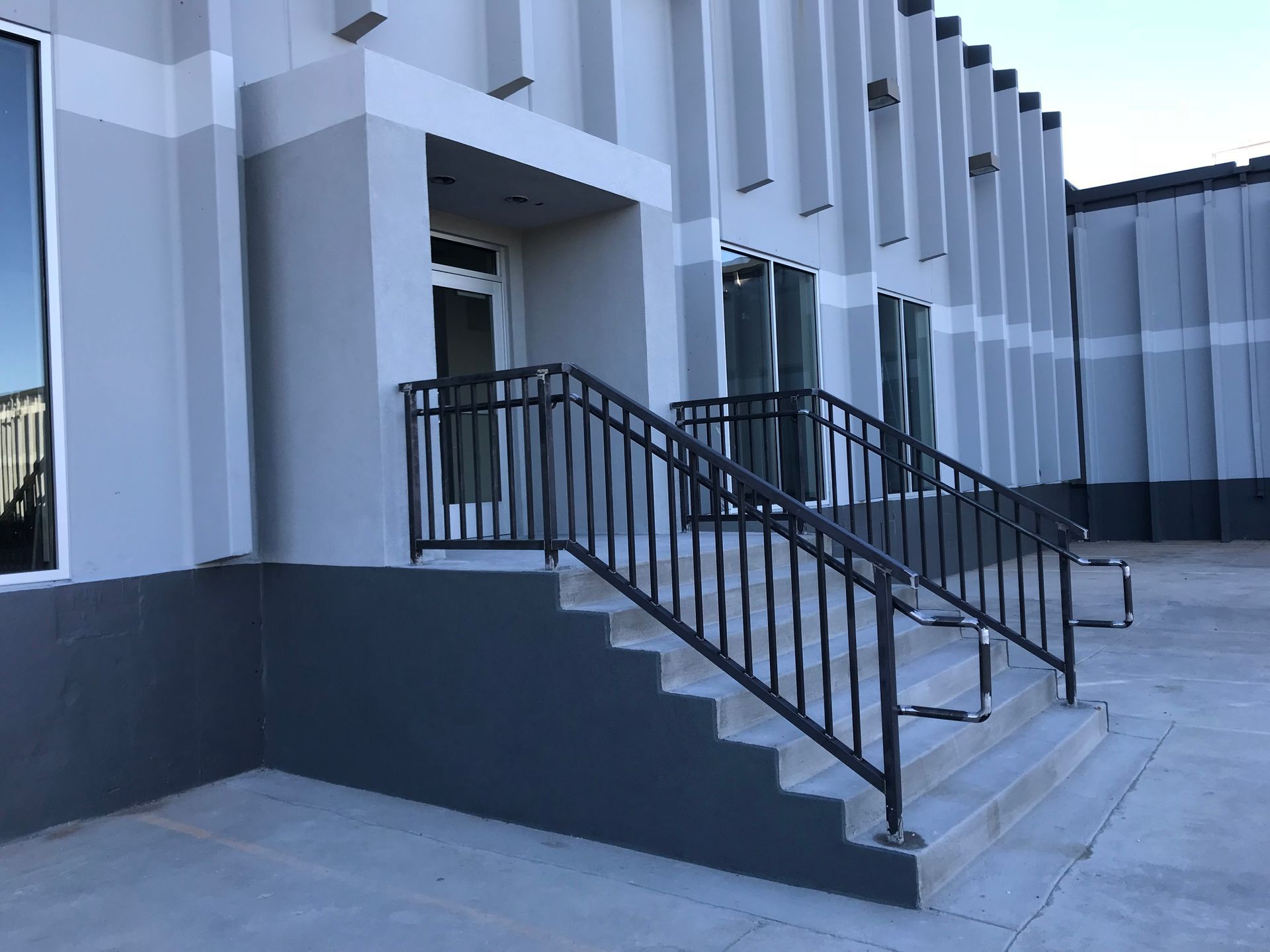 A building with stairs and a railing on the side of it.