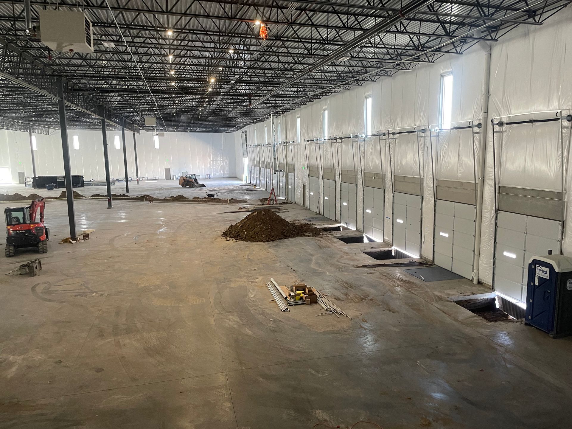 A large warehouse with a lot of doors is being built.