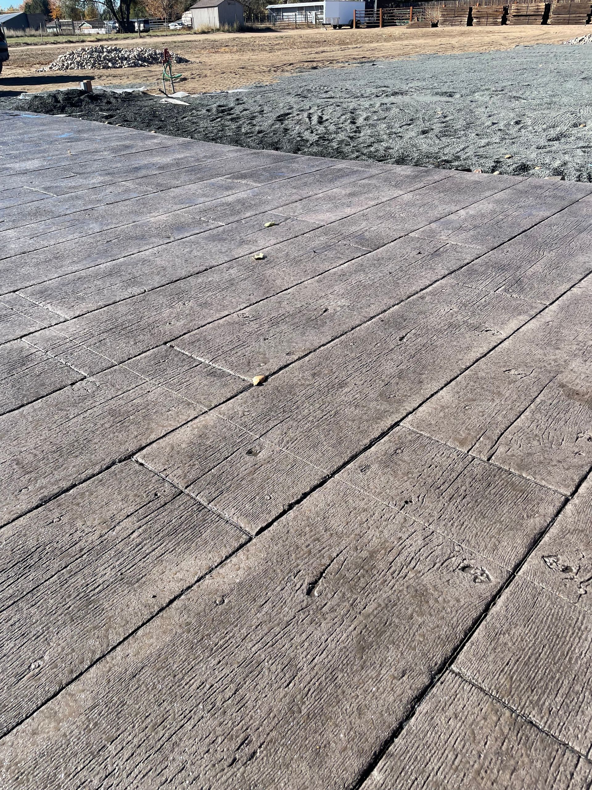 A close up of a concrete floor with a wood grain pattern.