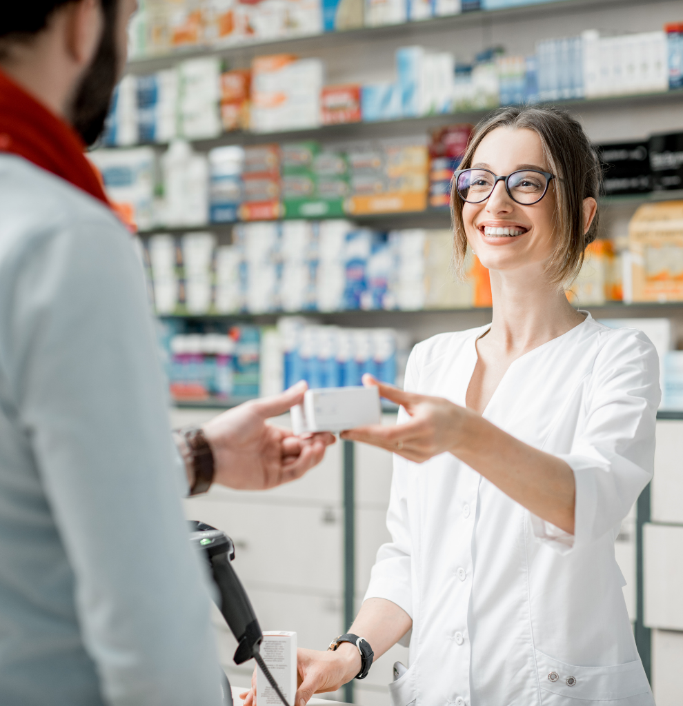 pharmacist handing medication to customer