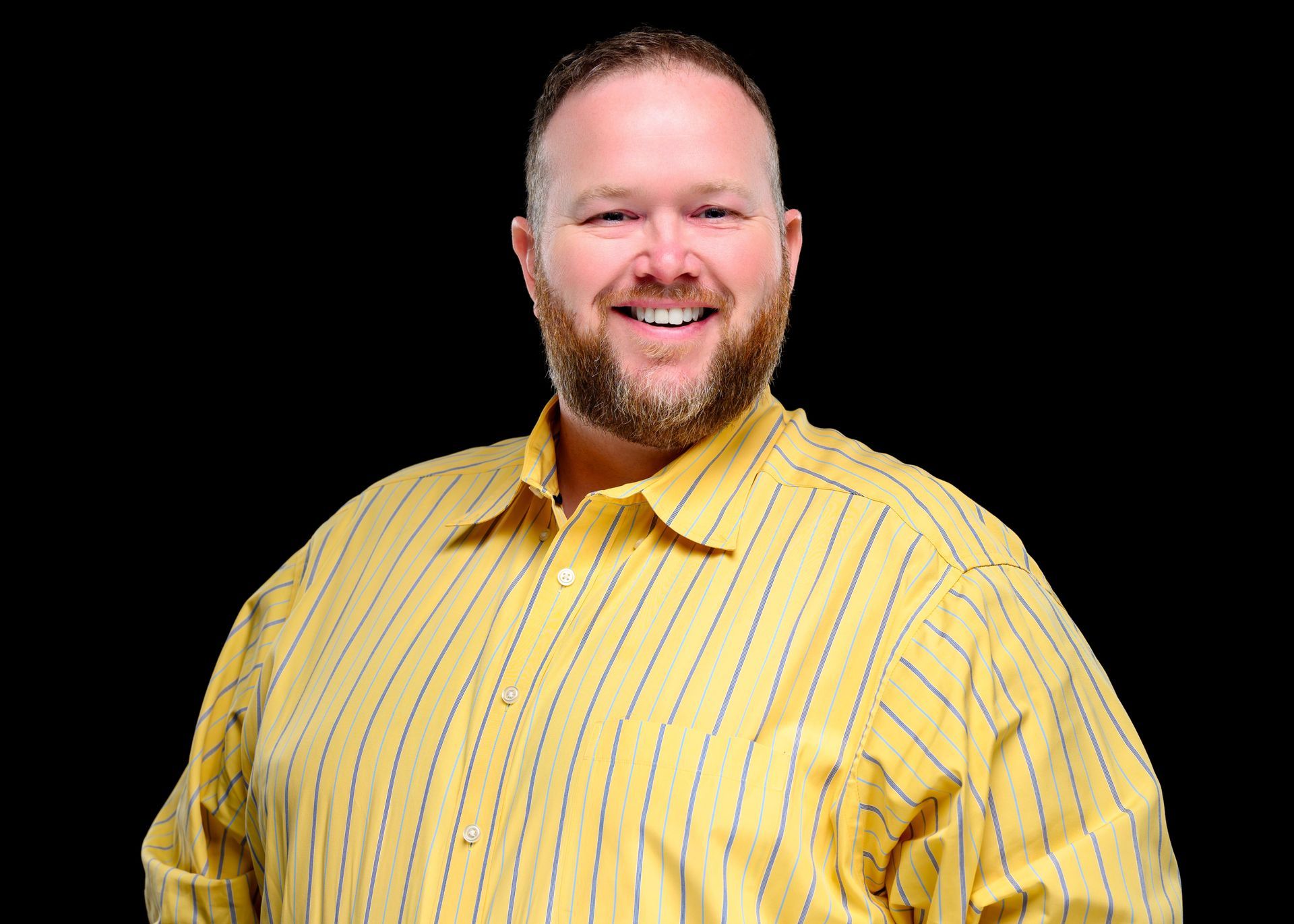 A large rocky mountain with a blue sky in the background.