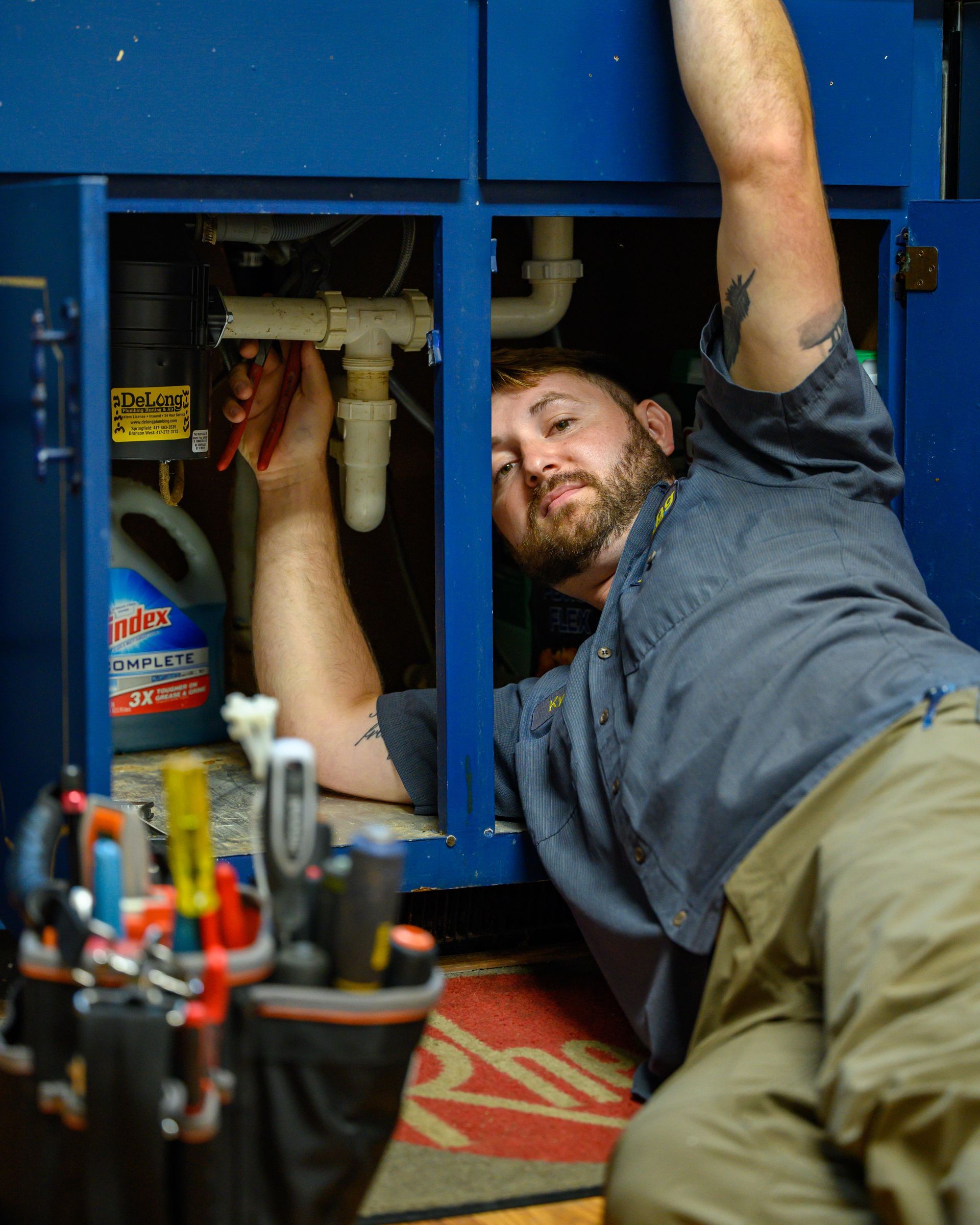 A waterfall is surrounded by rocks and trees