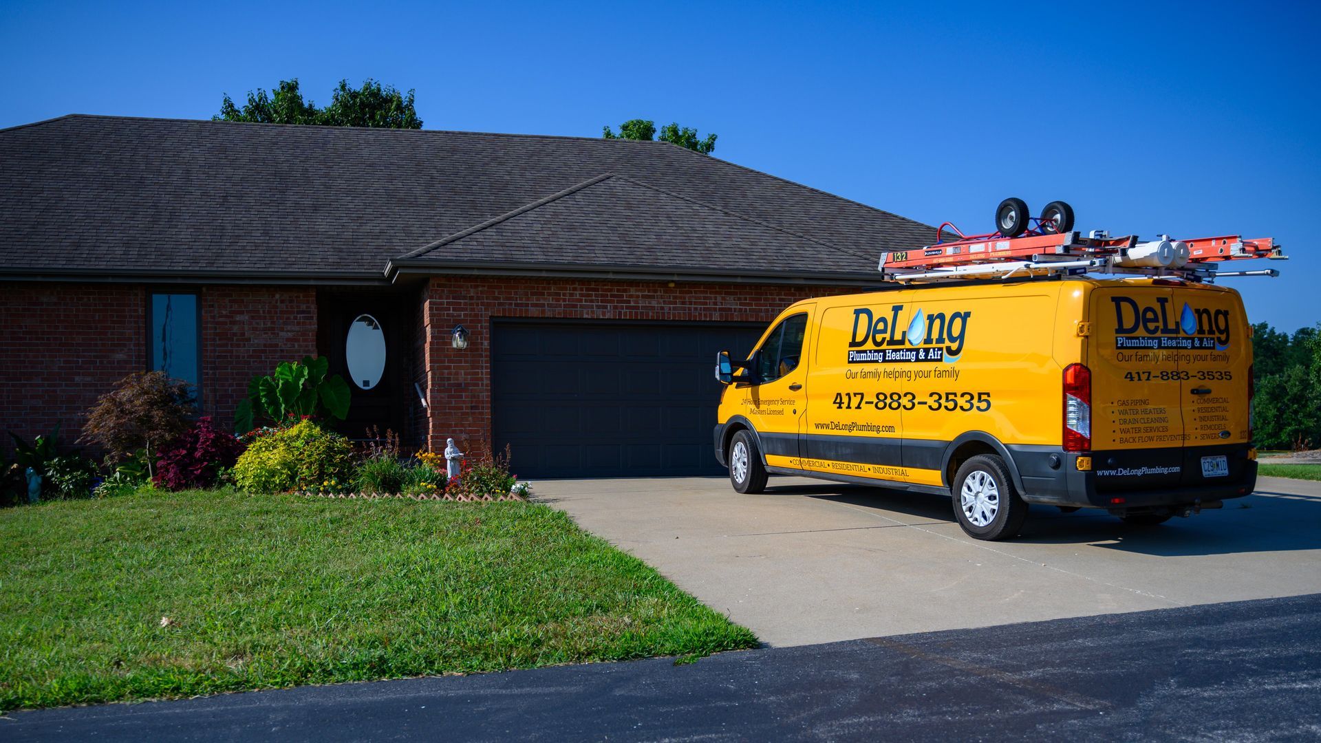 A plumber is fixing a faucet in a kitchen.