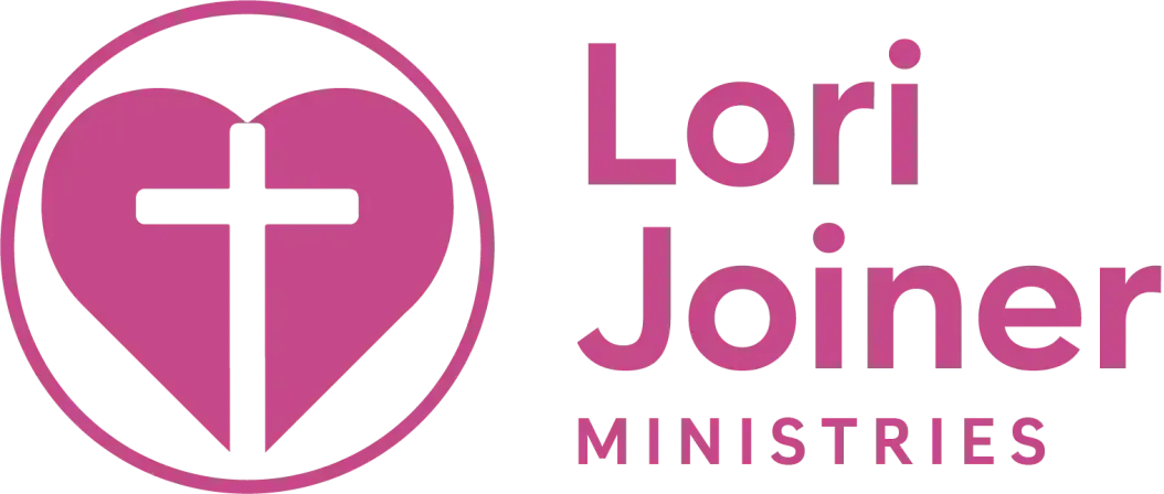 The logo for lori joiner ministries is a pink heart with a cross inside of it.