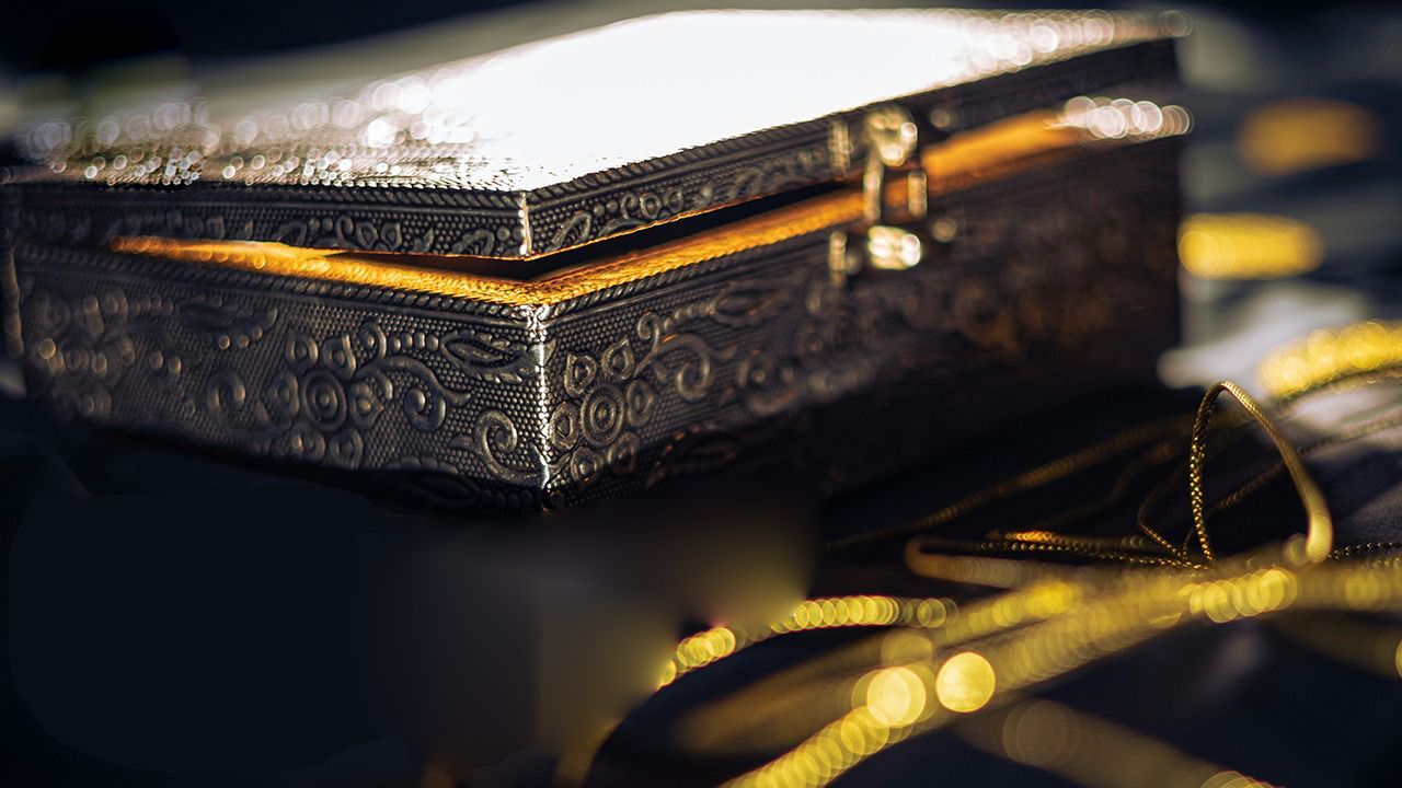 A black and gold box is sitting on top of a table.