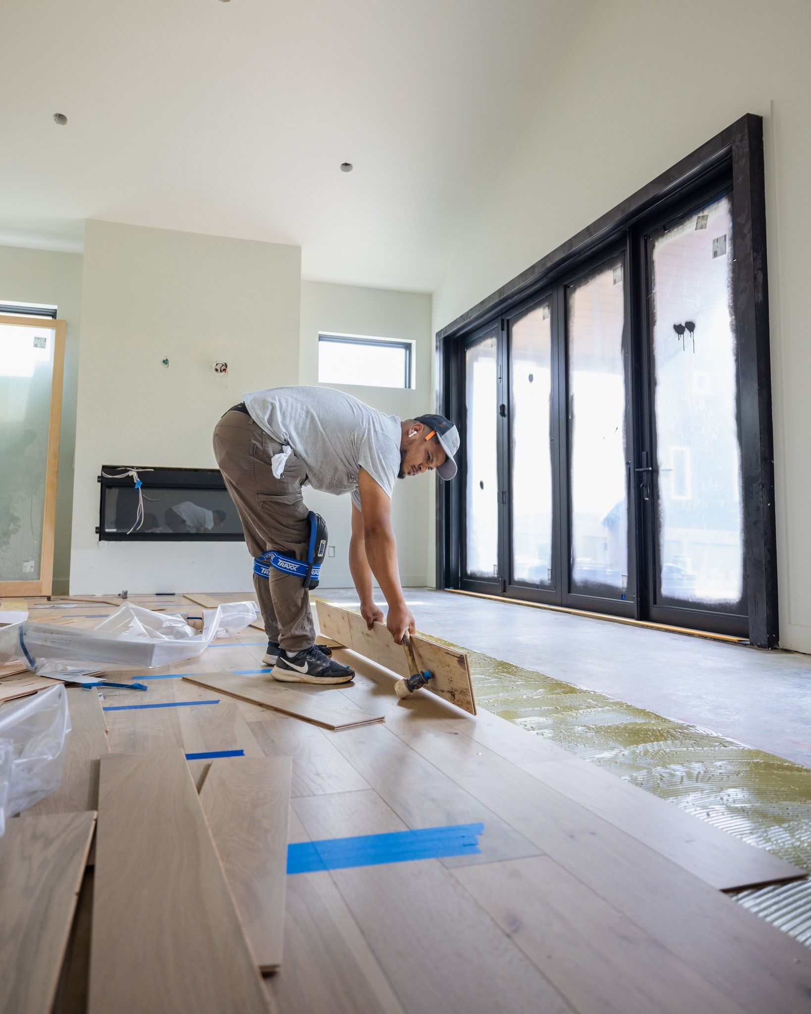 someone installing engineered hardwood in a home