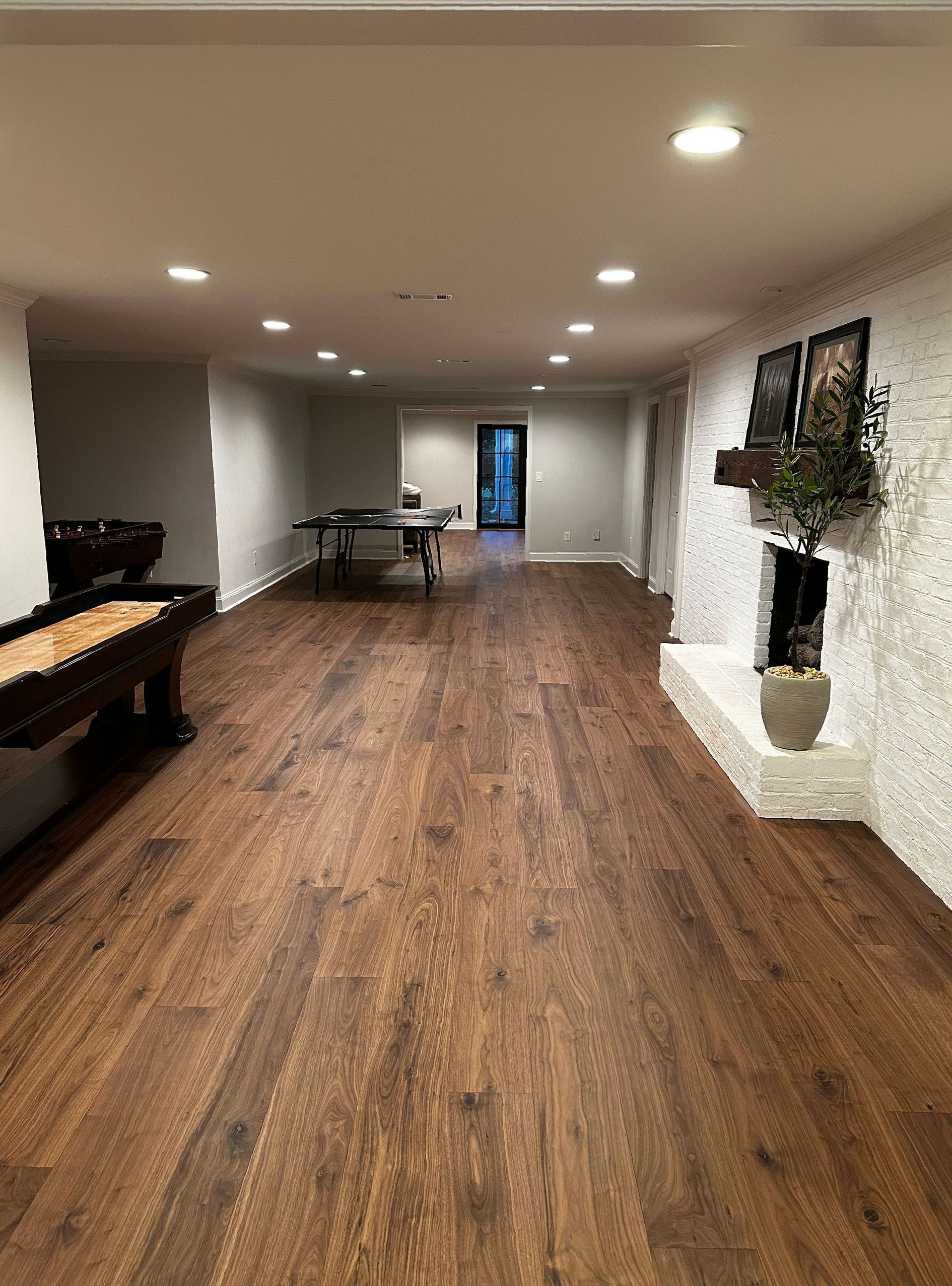 A living room with wide plank laminate flooring