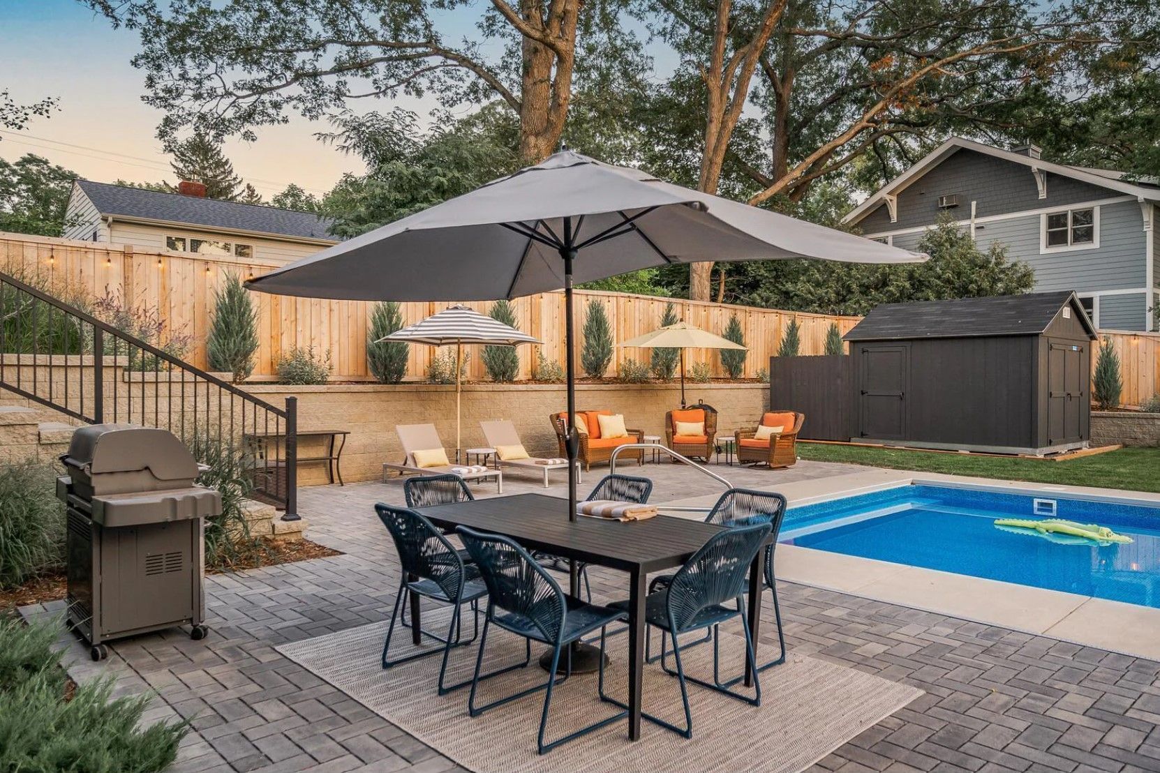 A patio with a couch two chairs and a coffee table