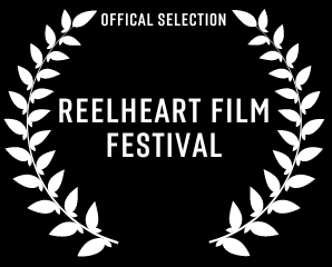 A white laurel wreath with the words reelheart film festival on it