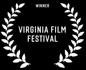 A white laurel wreath with the words `` virginia film festival '' on a black background.