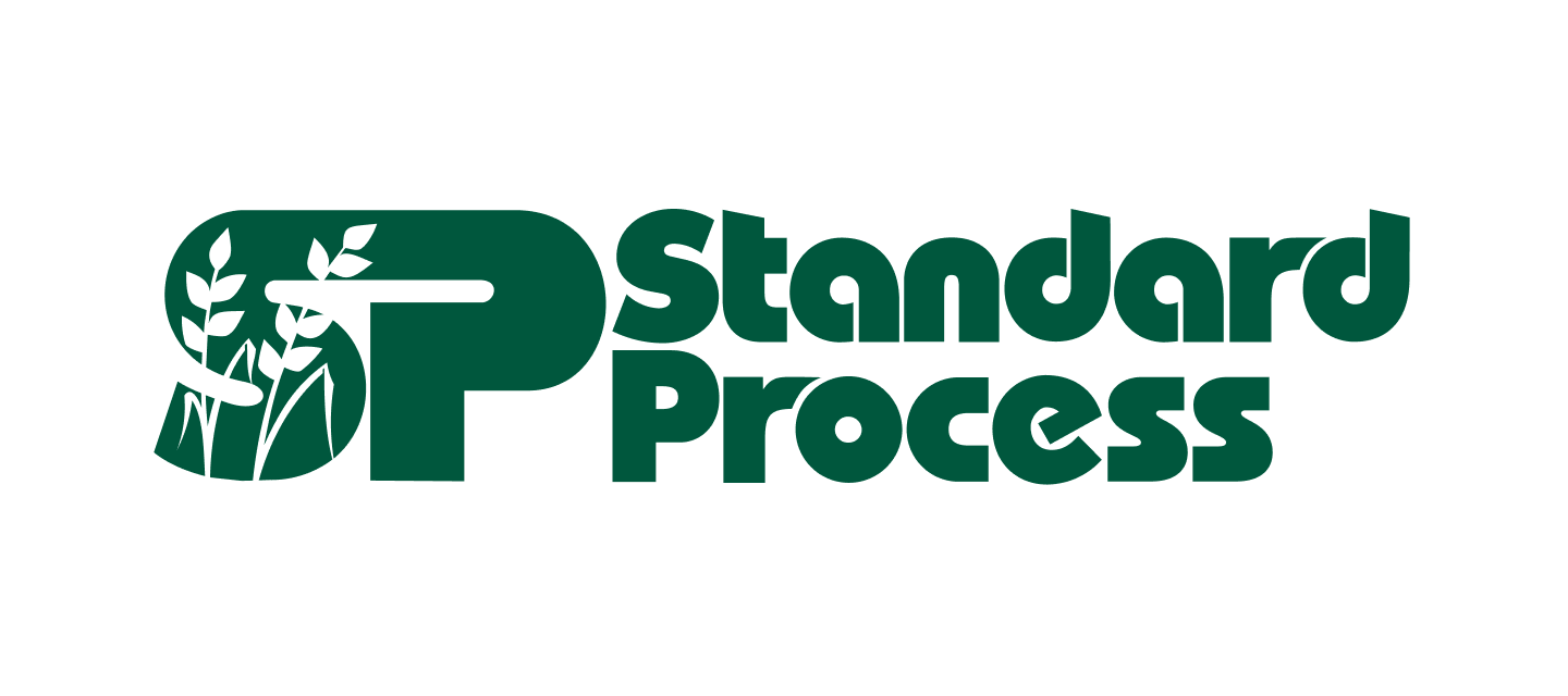A green and white logo for standard process with a tree in the background.