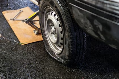 A man wearing white gloves is working on a brake disc.