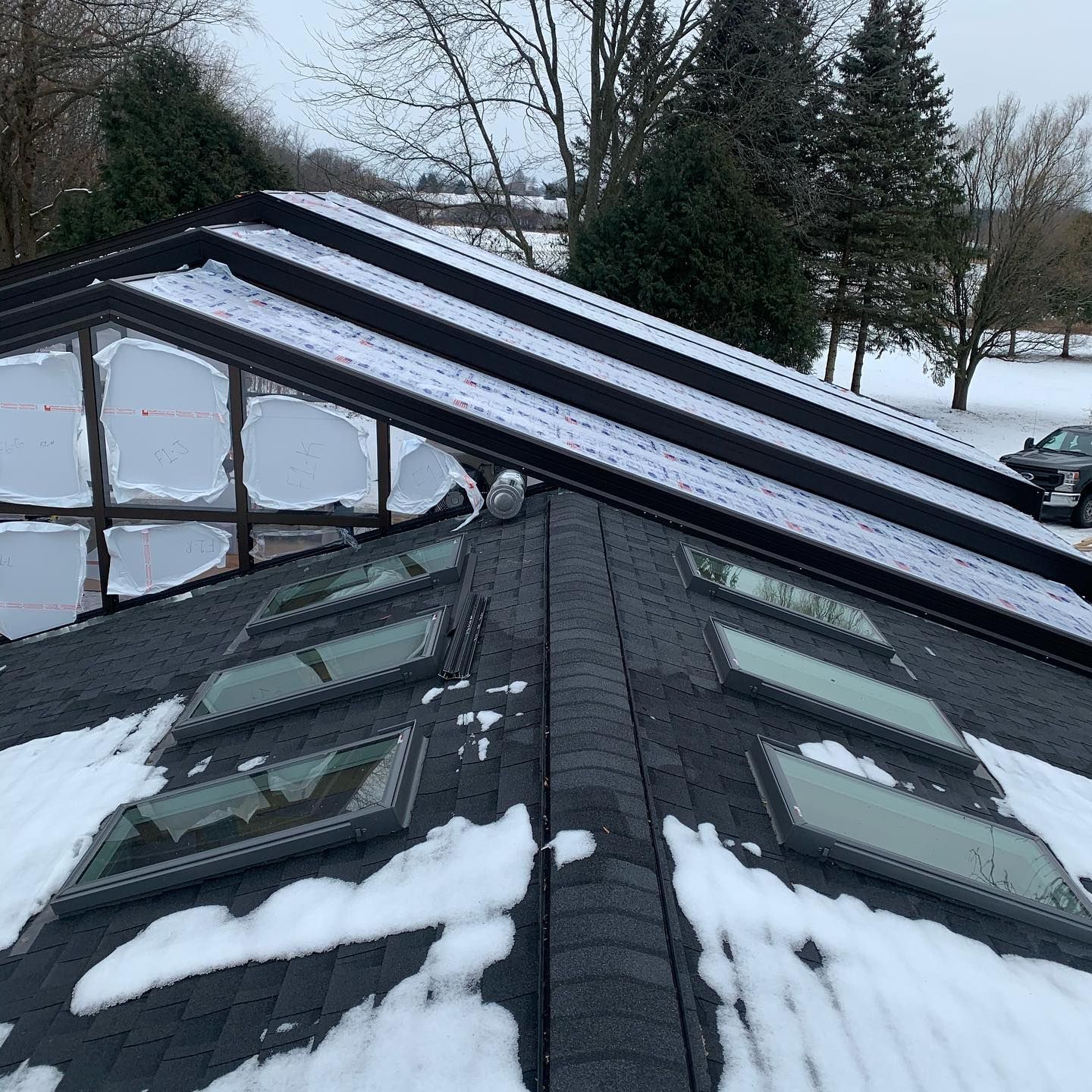 A roof with a lot of windows and snow on it.
