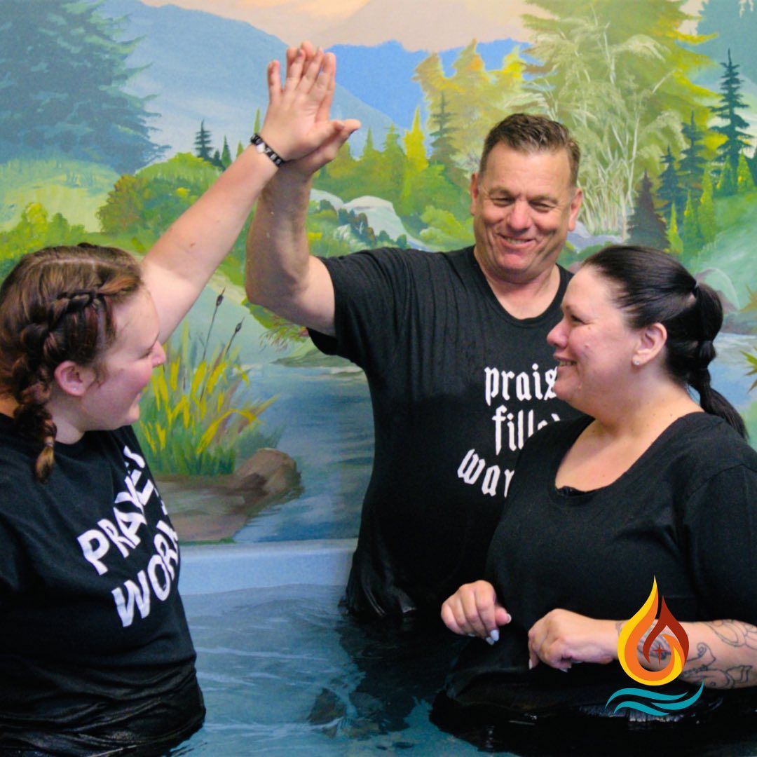 a man and two women are giving each other a high five