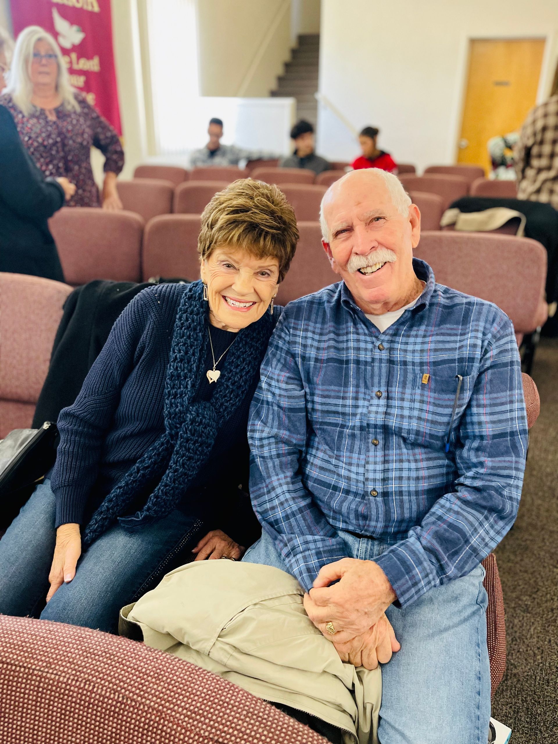 A man and a woman are posing for a picture in a church