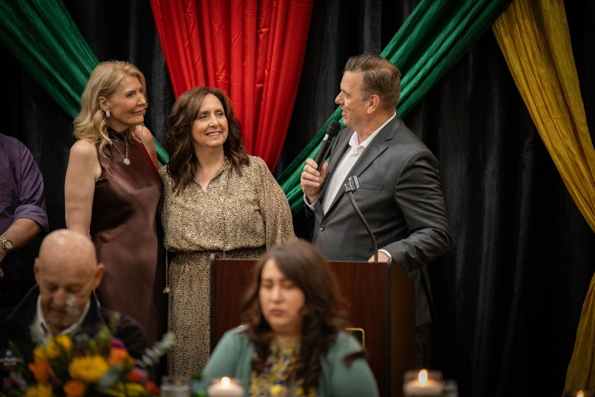 A man is standing at a podium giving a speech to a group of people.