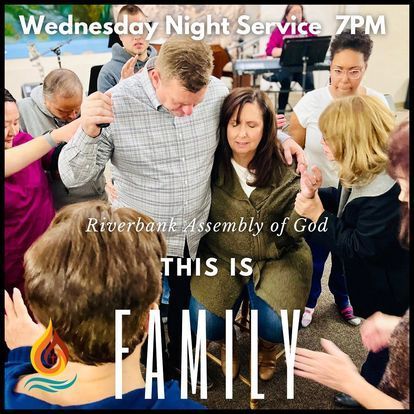 a group of people are standing around a man and a woman .