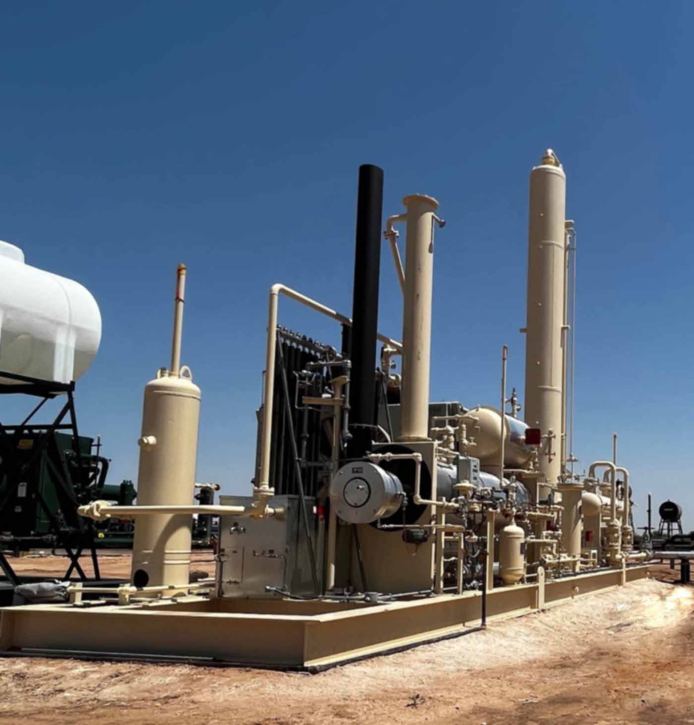 A large white tank sits in the middle of a factory