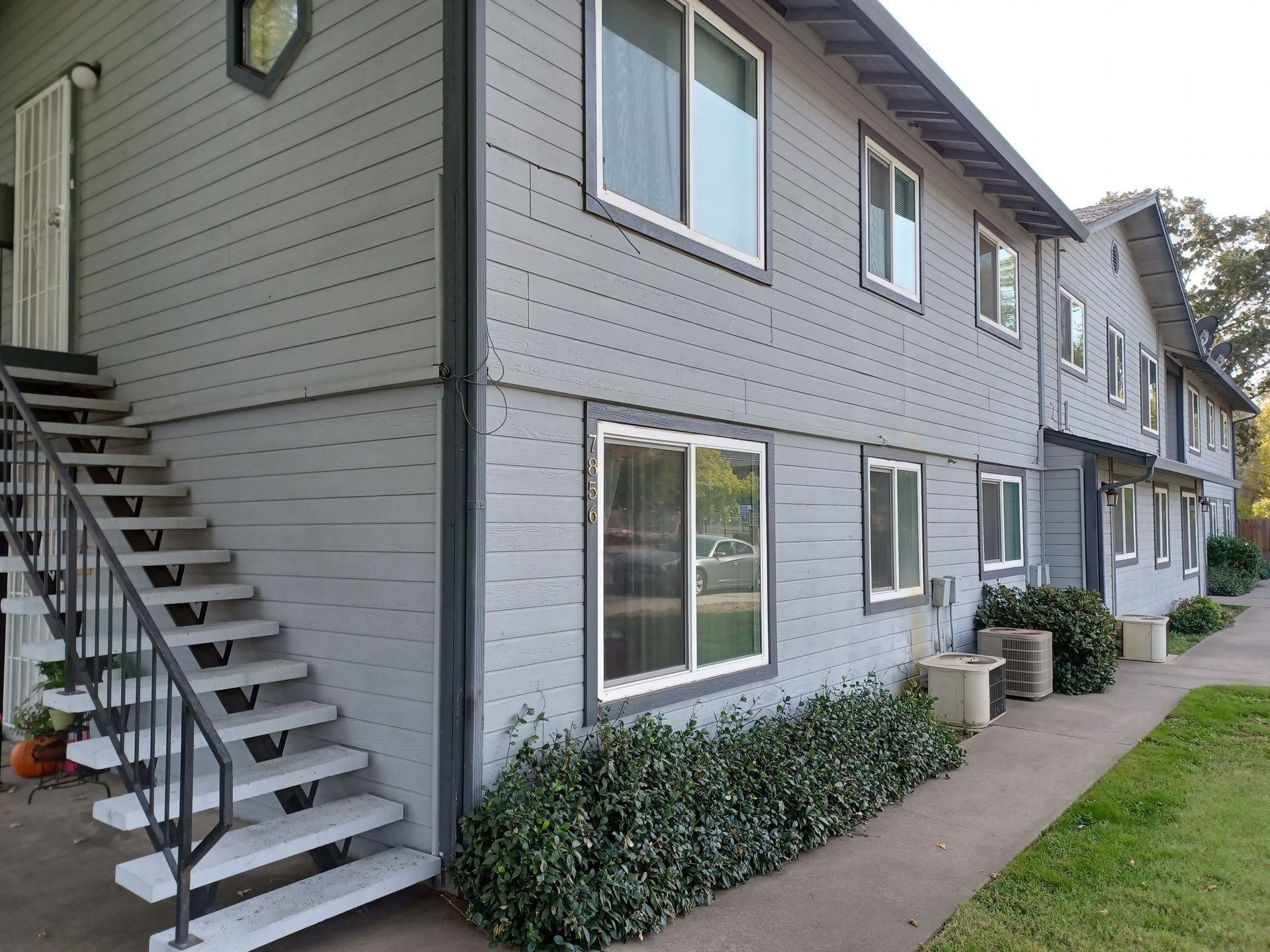 A building with stairs leading up to the second floor