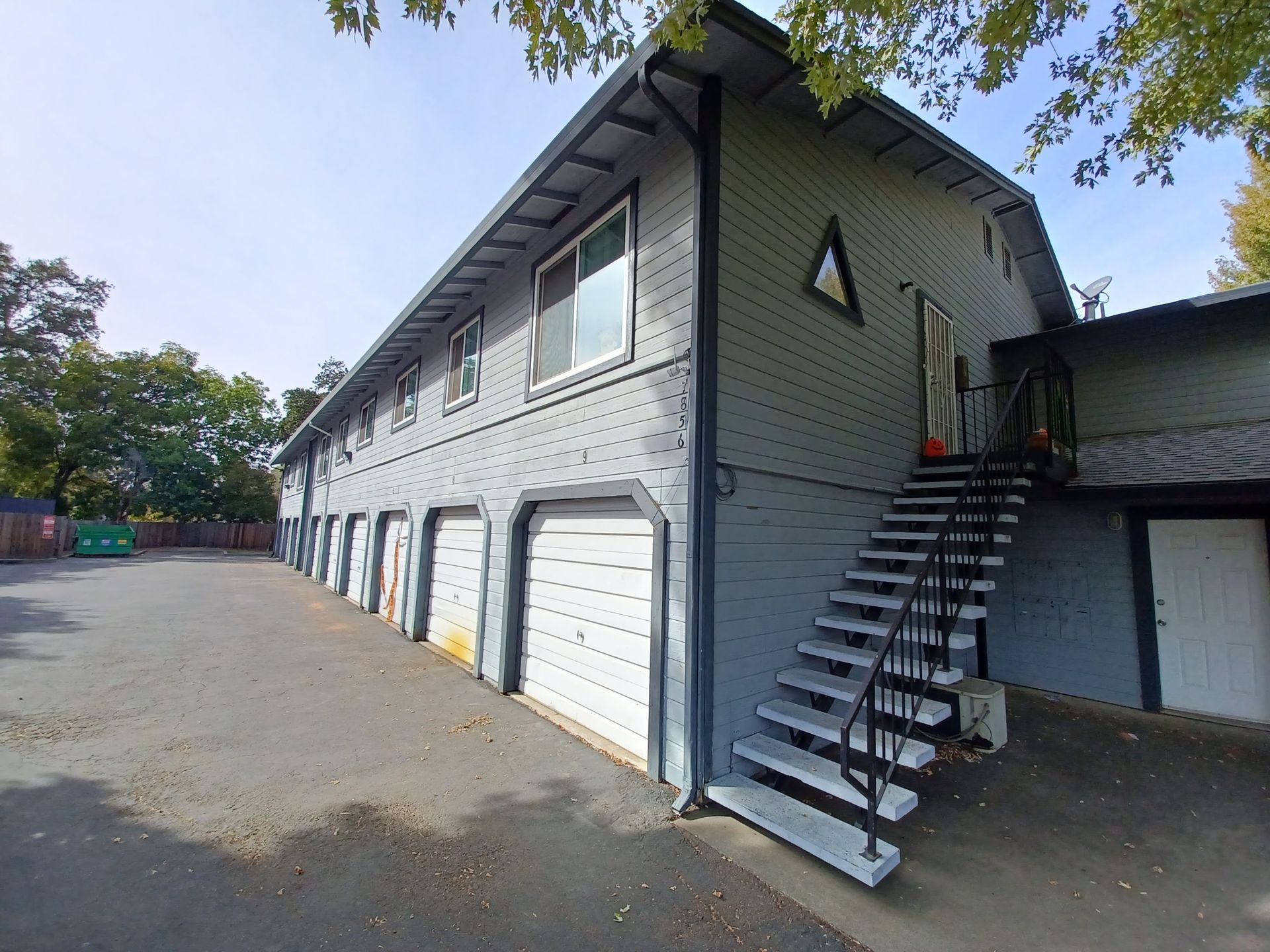 A building with stairs leading up to the second floor