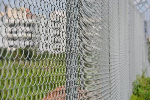 A close-up of a chain link fence surrounding a field