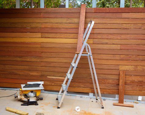 A newly stained wood privacy fence