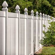 A new vinyl fence with ornamental caps.