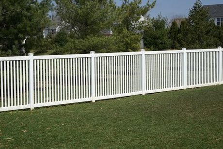 A newly installed white aluminum fence