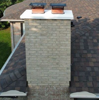 two chimneys on the roof of a house