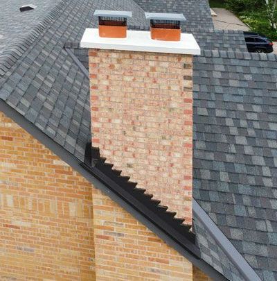 an aerial view of a brick chimney on top of a roof