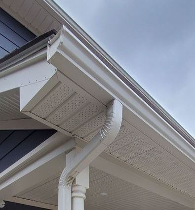 a close-up of a white eaves trough on the side of a house