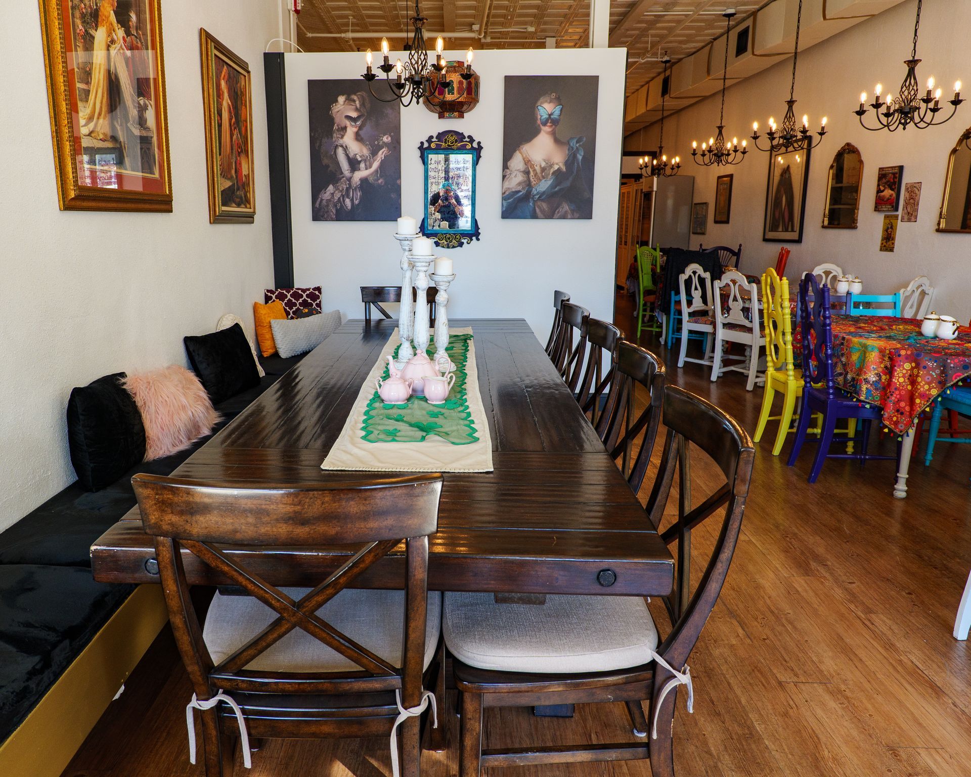 A dining room with a long wooden table and chairs