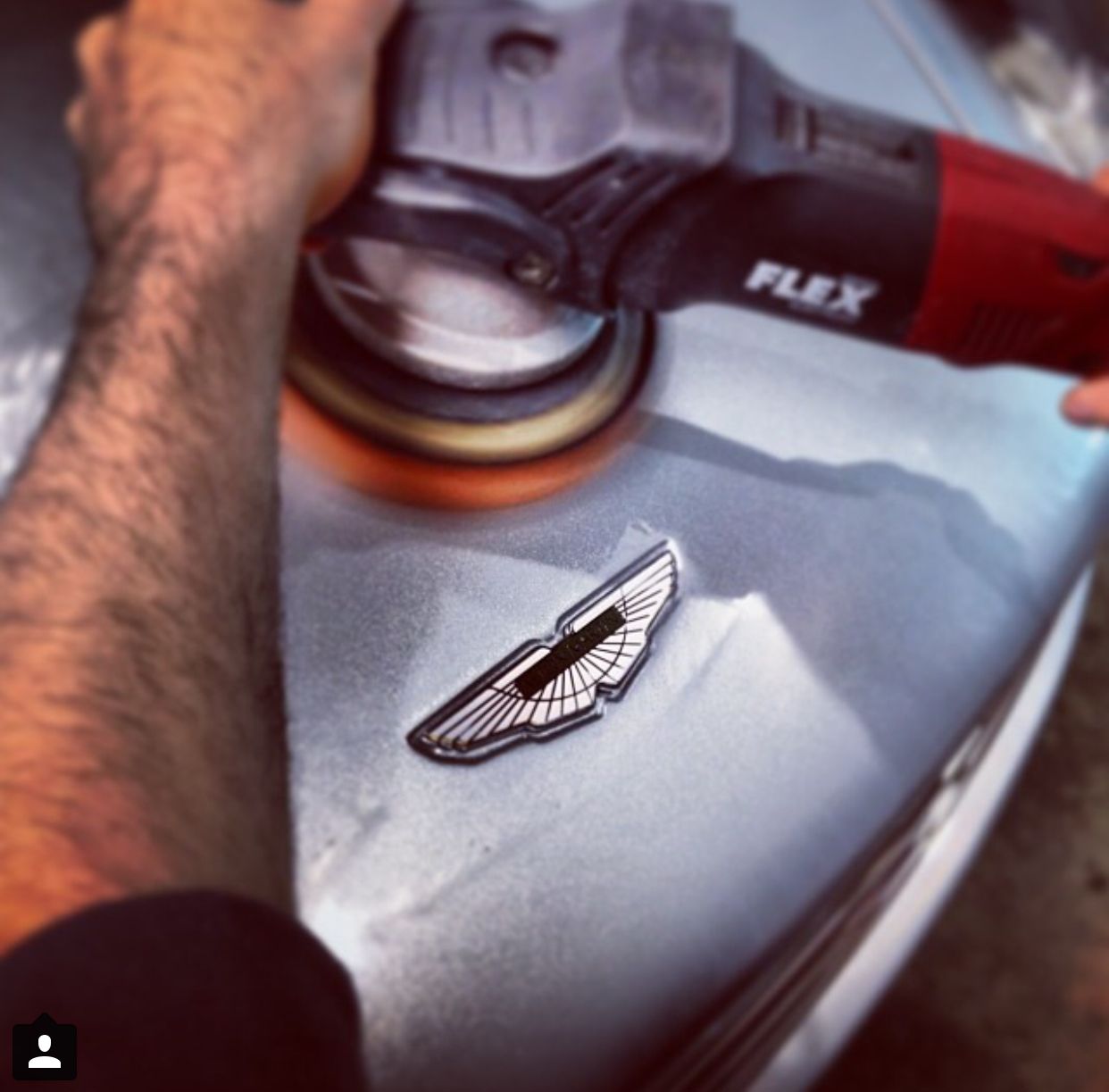 A person is polishing a car with a flex tool