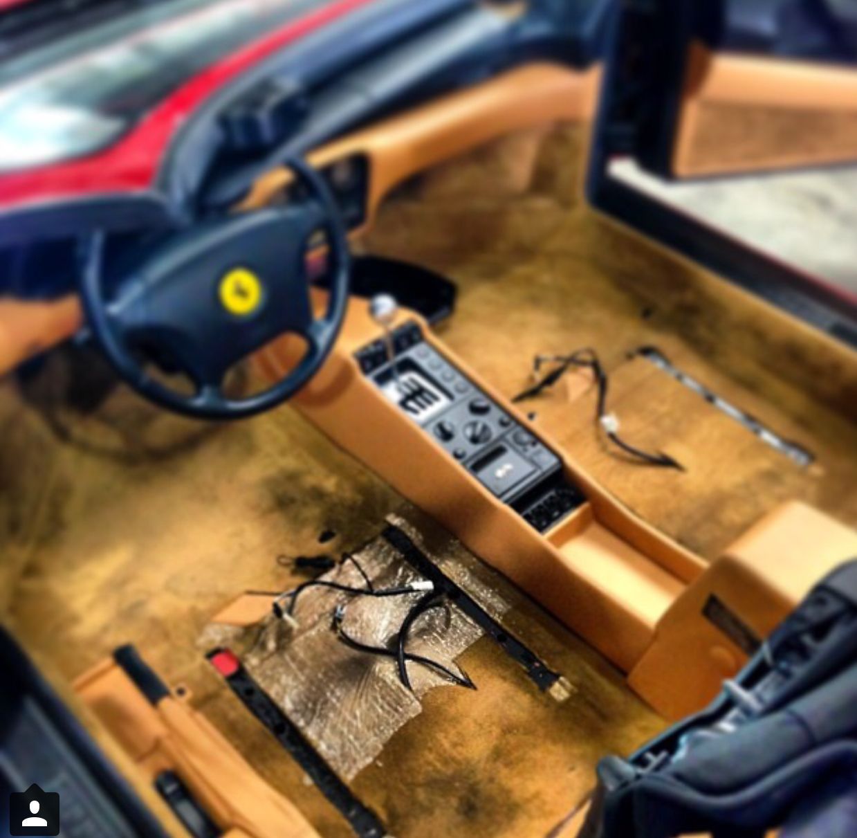 The inside of a car with a yellow steering wheel