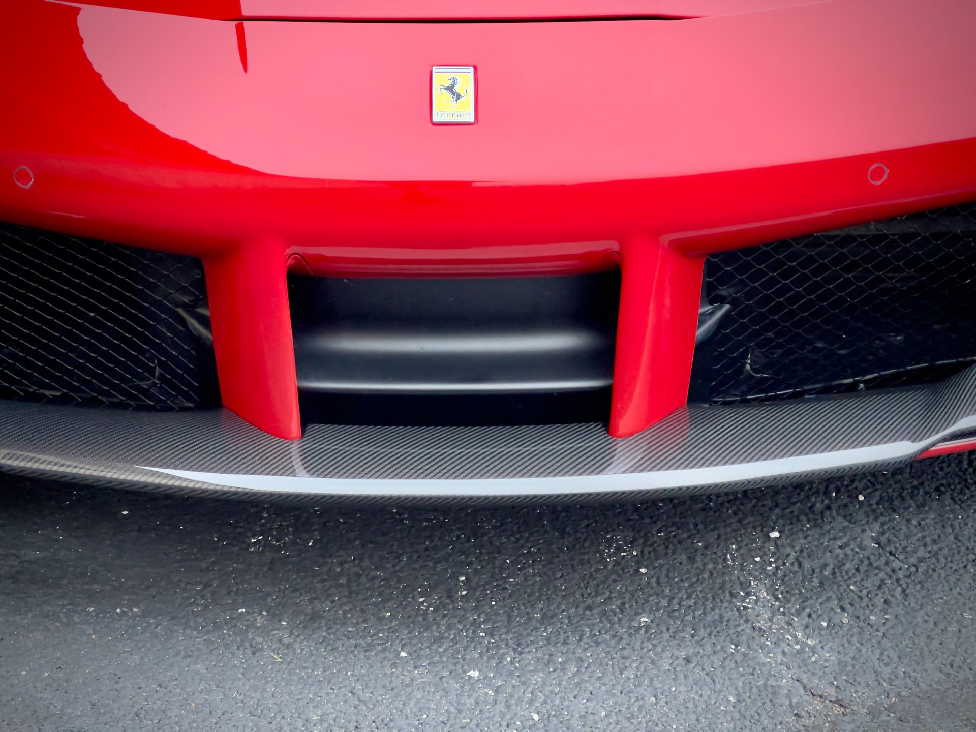 A close up of the front of a red ferrari