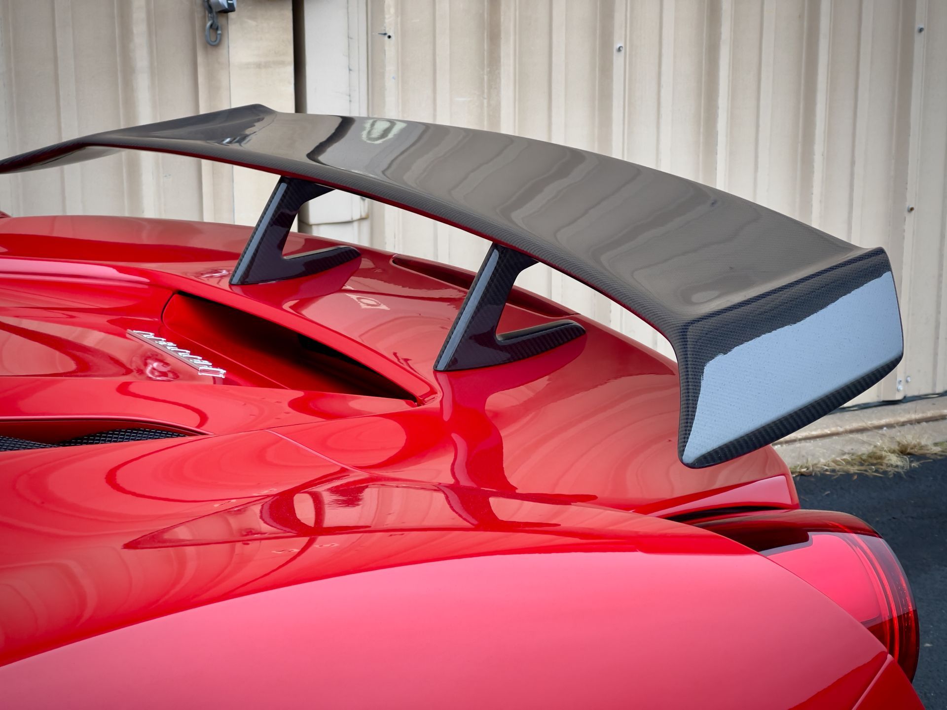 A red sports car with a spoiler on the back of it