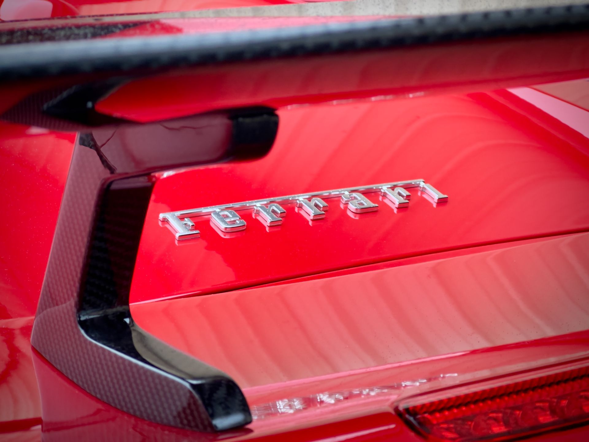 The rear end of a red ferrari sports car