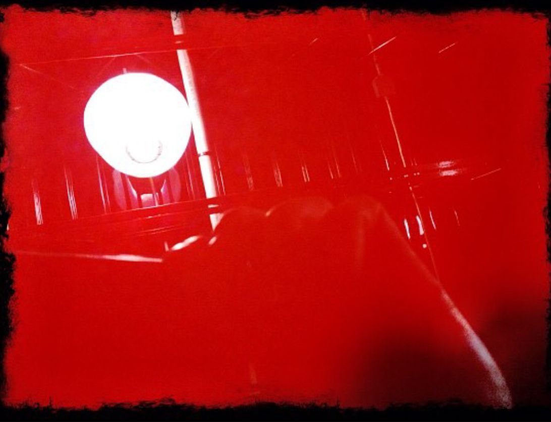 a close up of a red surface with white dots on it .