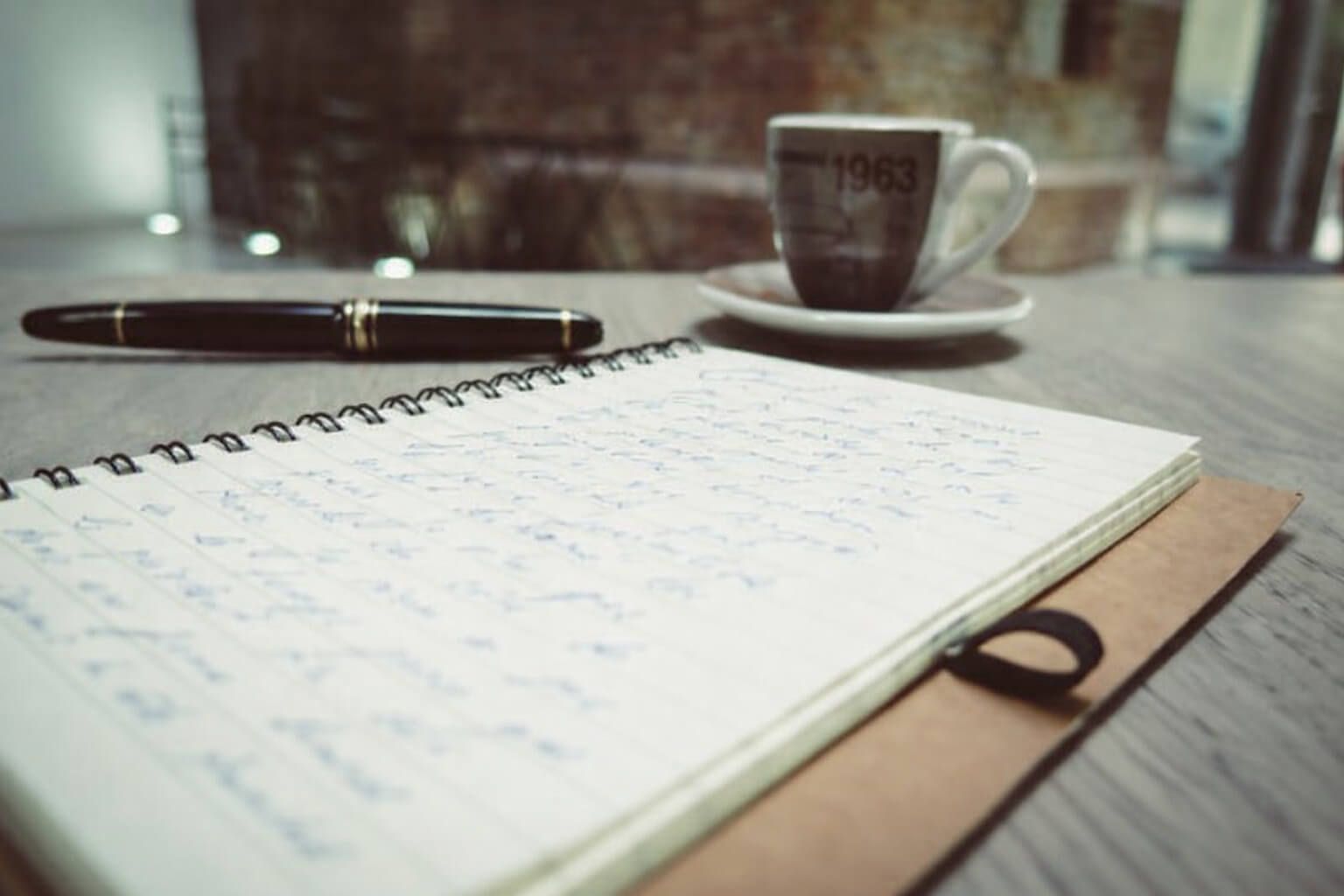 A notebook, pen, and coffee cup create a thoughtful planning setting for funeral homes Arlington, TX