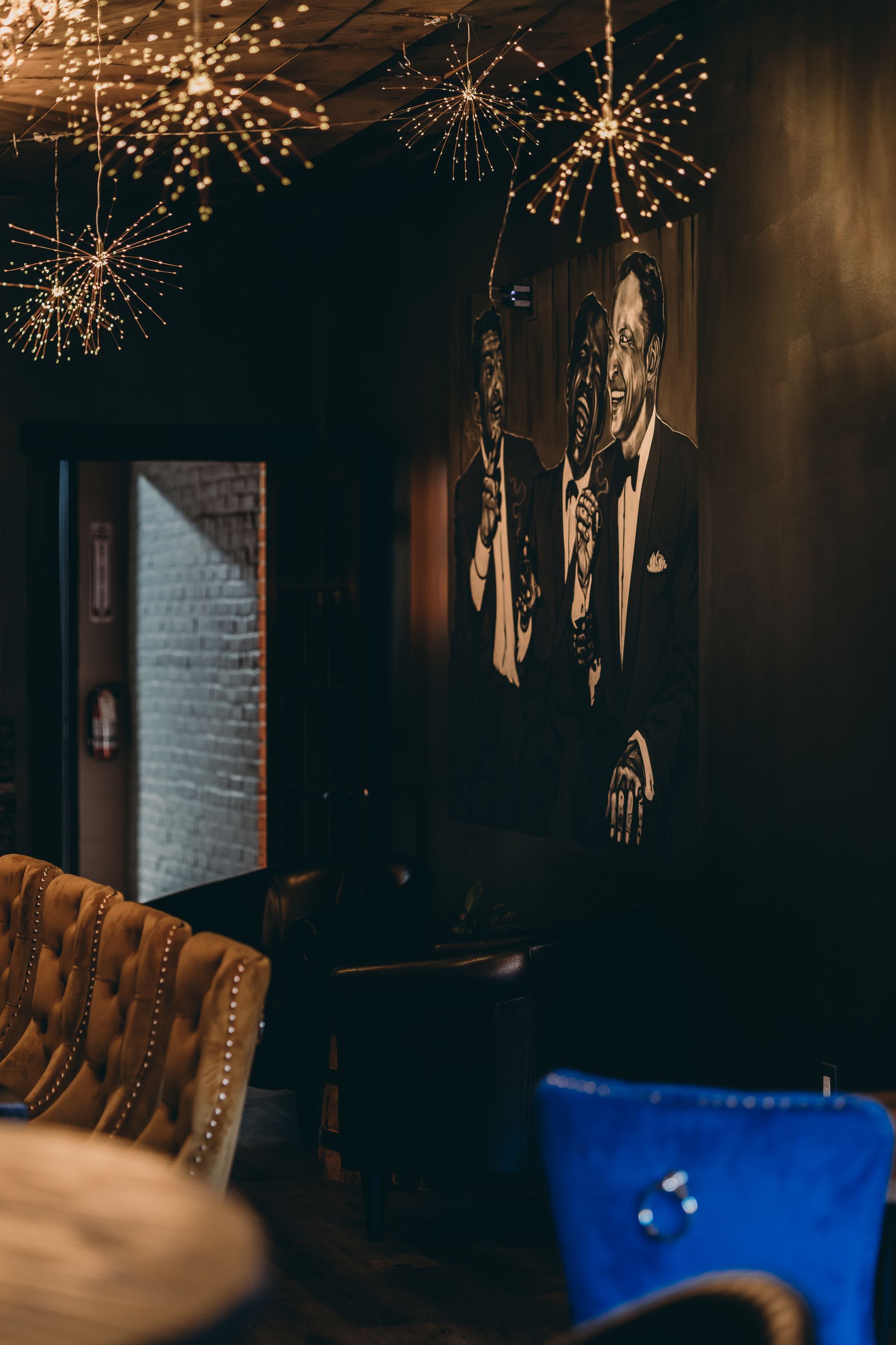 There is a painting of the 'Rat Pack' on the wall.